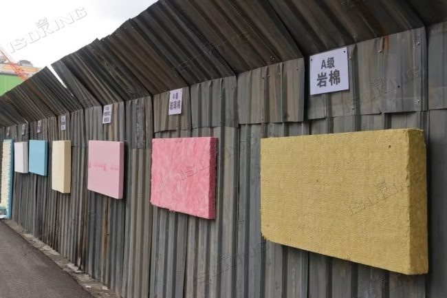 A comparison display featuring fiberglass batt insulation and mineral wool slabs, showcasing different insulation solutions.