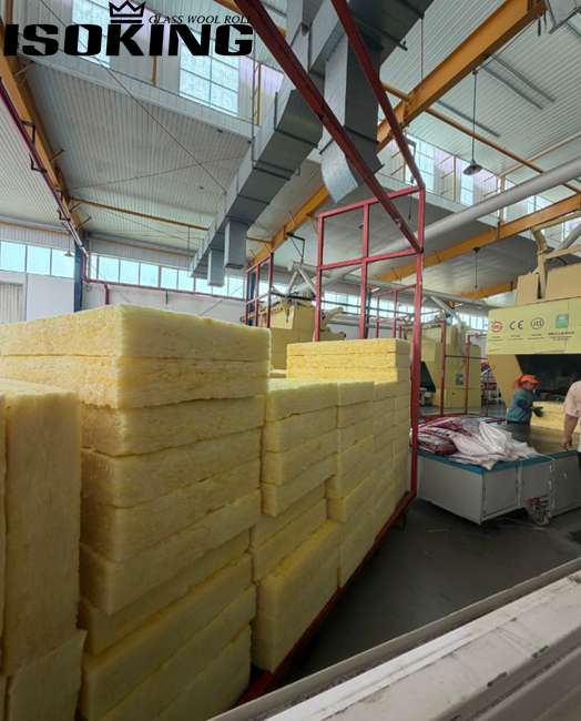 IKING yellow glass wool batts neatly stacked in a modern warehouse, high quality fiberglass insulation products ready for international shipment, clean industrial storage environment