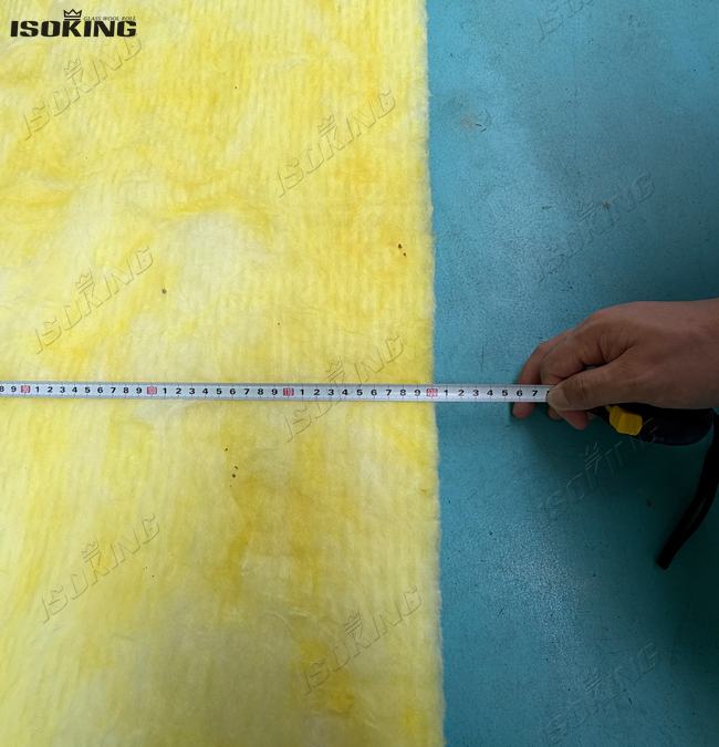 Verifying standard roll dimensions and width accuracy during foil backed fiberglass insulation production.